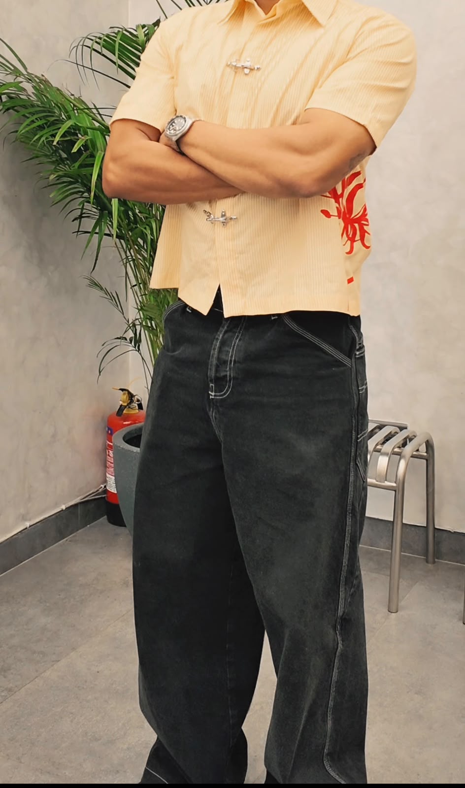 Bumblebee Clasp Shirt worn untucked with black jeans, showing the relaxed cropped fit